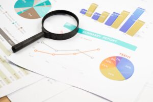 Financial reports and business performance charts under review, illustrating the importance of identifying financial issues before they become costly problems.